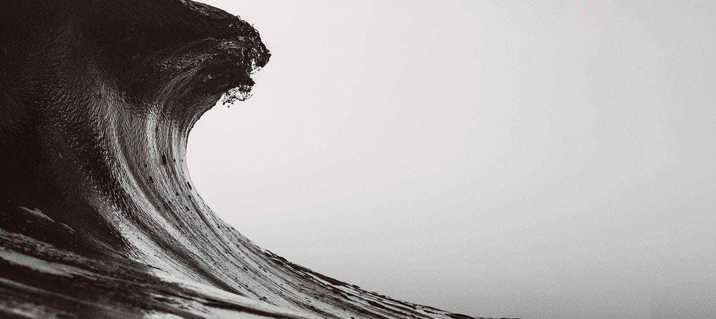 black and white shot of cresting wave. Image links to short video about Rip Curl