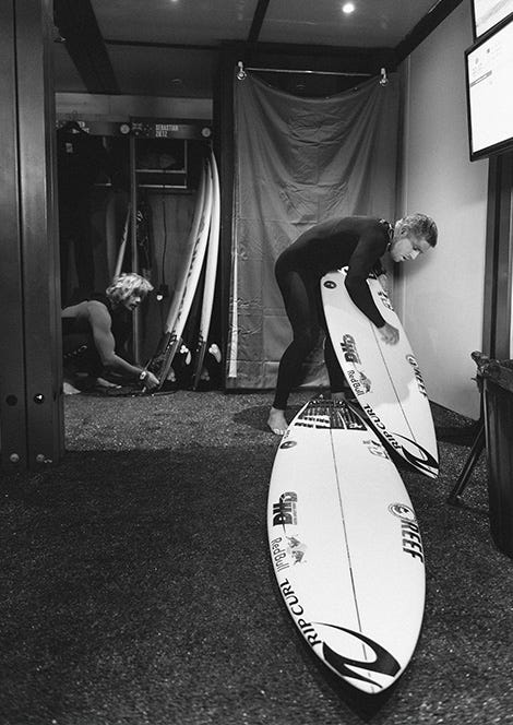 Mick Fanning waxing his surf board